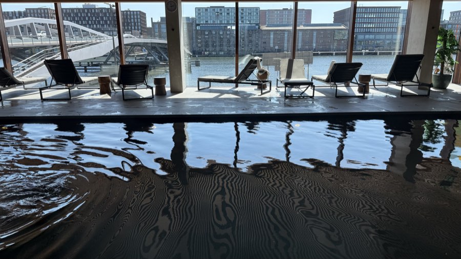 Pool and loungers facing the water